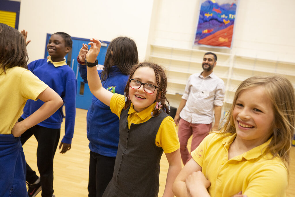 Primary school students in a school hall.