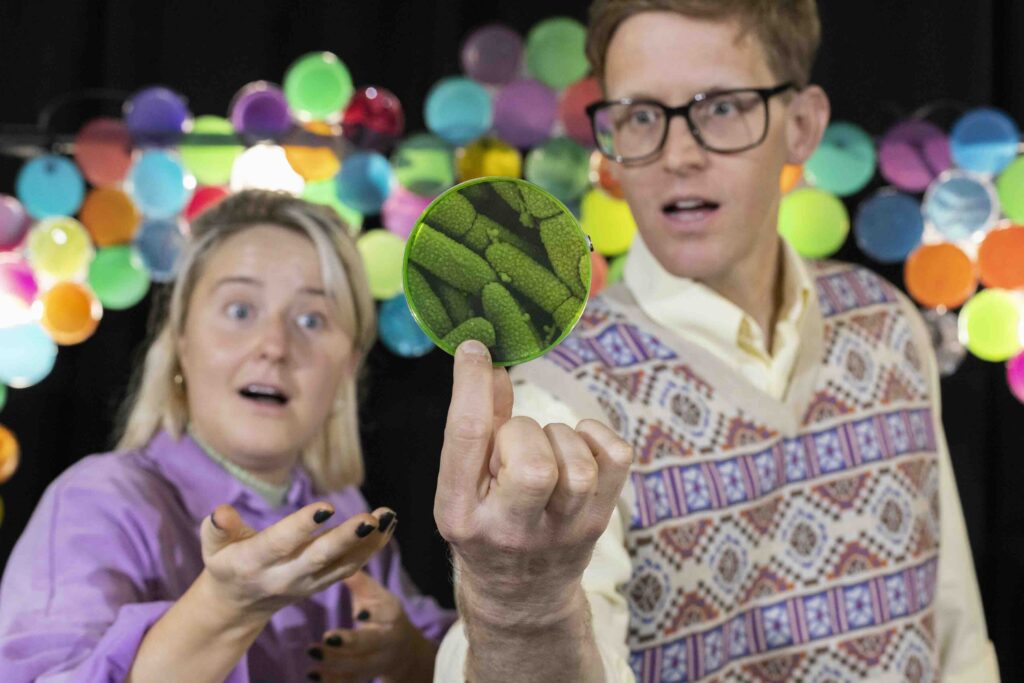 Facilitators for Marvellous Microbes looking in wonder at a picture of a microbe.