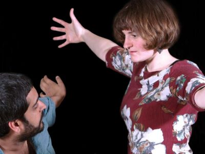 Two researchers with aims outstretched performing