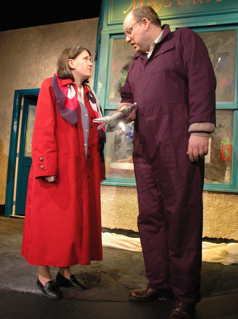 Annie and Gordon dressed in costume on a stage.