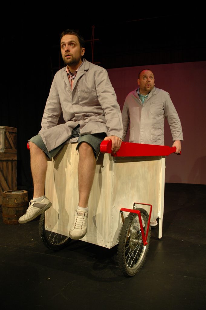 Gordon and Mark on stage in costume. 