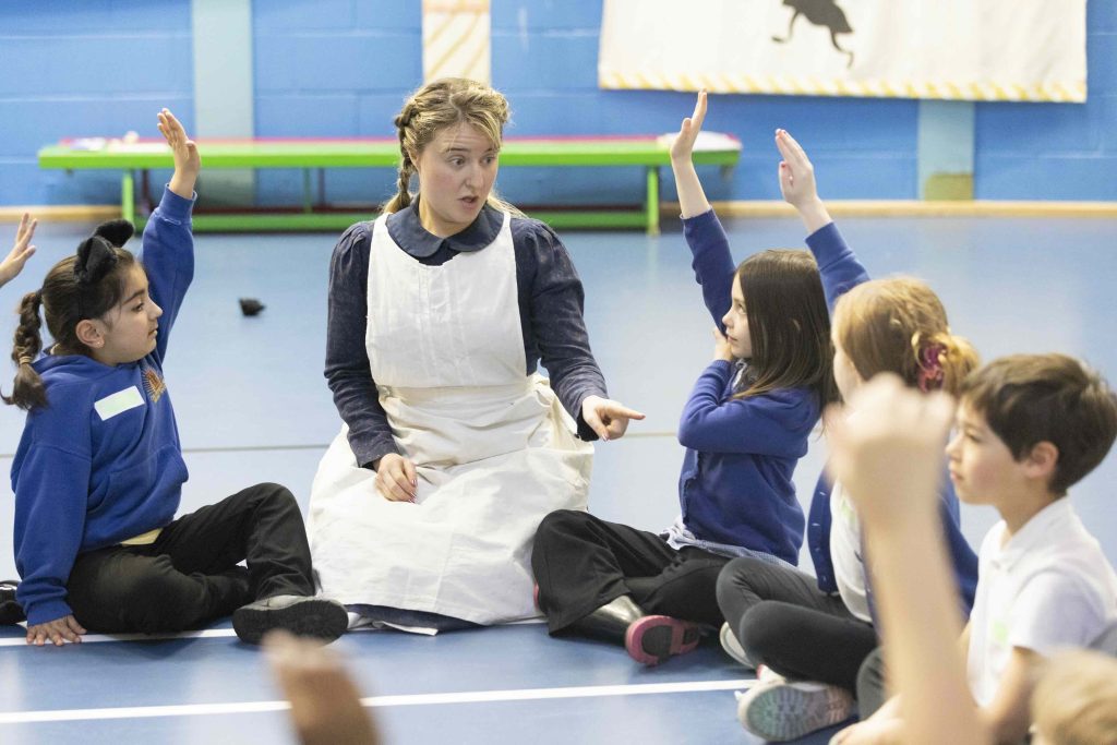 Jeannie interacting with group of childing during school workshop