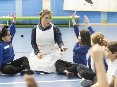 Jeannie interacting with group of childing during school workshop